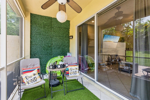 sunroom / solarium featuring ceiling fan