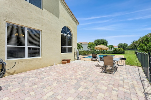 view of patio with a fenced in pool