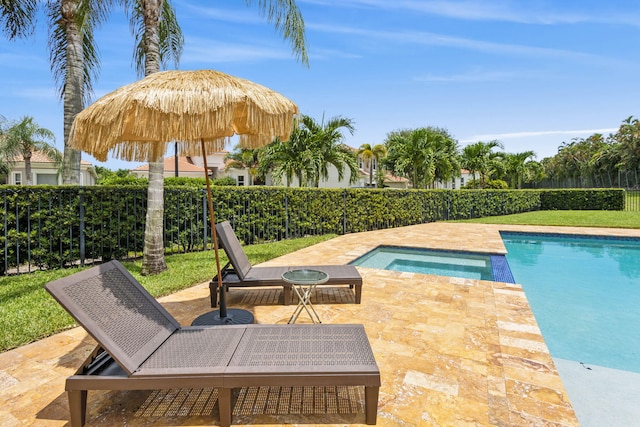 view of pool with a patio area and an in ground hot tub