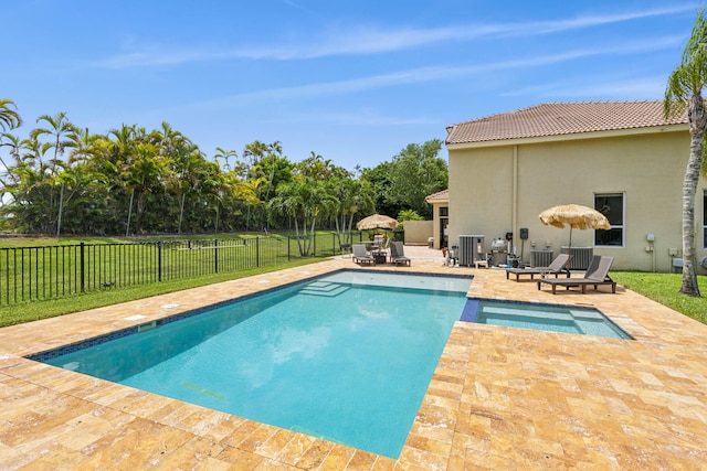 view of swimming pool with cooling unit, a patio area, and a yard