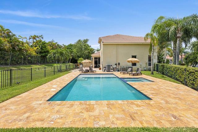 view of swimming pool featuring a patio area and cooling unit