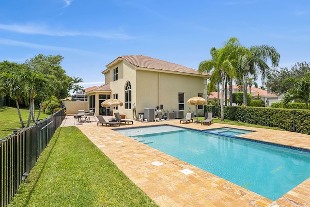 view of pool with a patio area and a yard