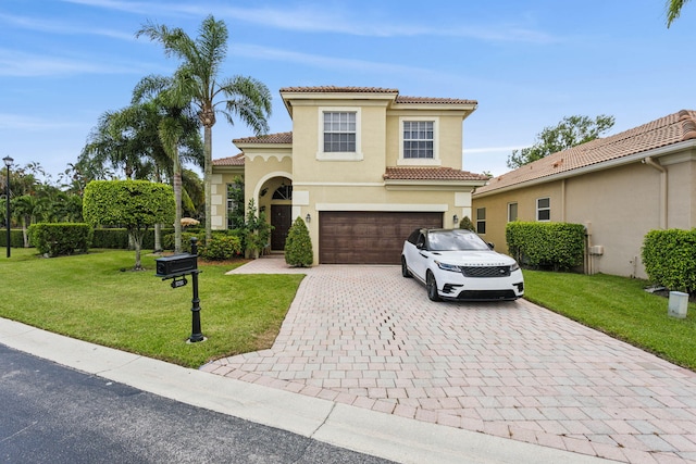 mediterranean / spanish house with a front lawn and a garage