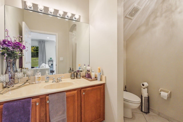 bathroom with tile patterned flooring, toilet, and vanity