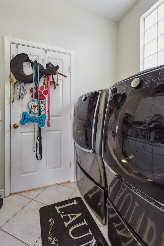 laundry area with light tile patterned floors and separate washer and dryer