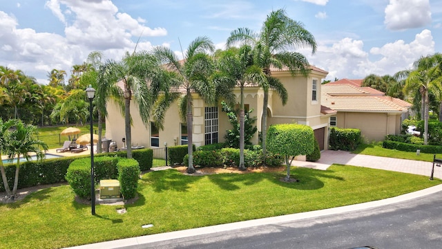 mediterranean / spanish-style home with a front yard