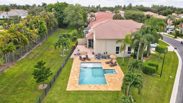 view of swimming pool featuring a patio area and a lawn