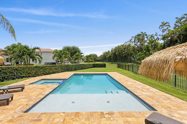 view of swimming pool with a patio area and a yard