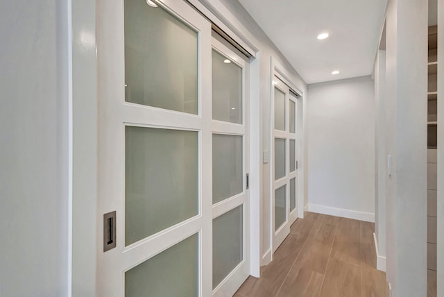 hall with light hardwood / wood-style floors