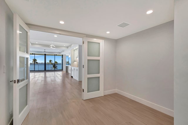 corridor with light hardwood / wood-style flooring