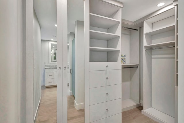 spacious closet featuring light wood-type flooring