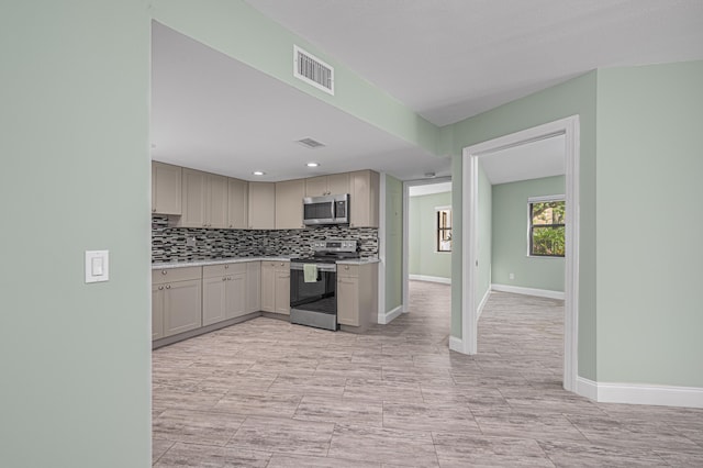 kitchen with backsplash, stainless steel appliances, light tile patterned flooring, and gray cabinetry