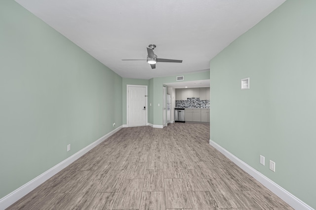 unfurnished living room with ceiling fan and light hardwood / wood-style flooring