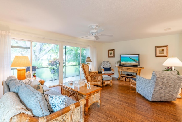 living room with ceiling fan, a healthy amount of sunlight, and hardwood / wood-style flooring