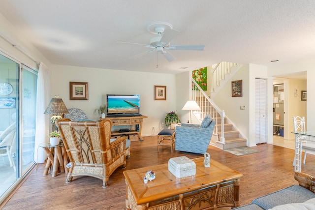 living room with ceiling fan and hardwood / wood-style flooring