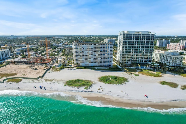 birds eye view of property featuring a beach view and a water view