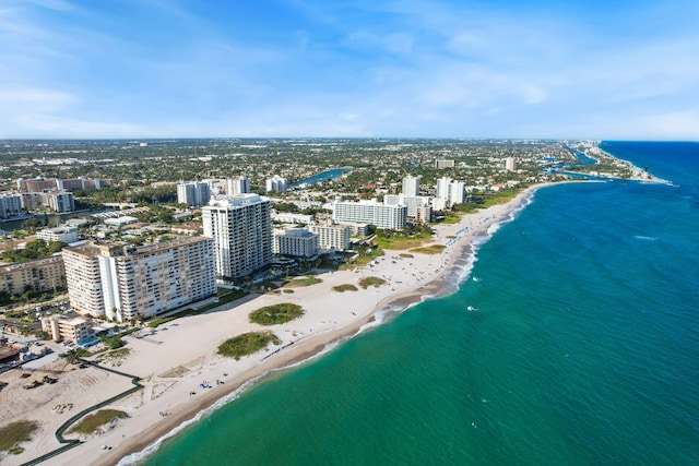 drone / aerial view with a beach view and a water view