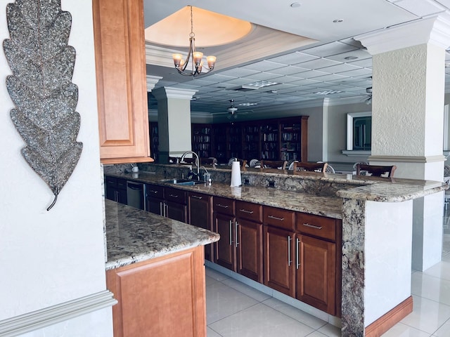 kitchen with a chandelier, stone countertops, light tile patterned floors, sink, and kitchen peninsula