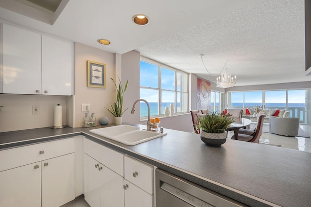 kitchen featuring sink, a water view, and a healthy amount of sunlight