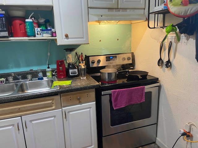 kitchen with white cabinets, stainless steel range with electric stovetop, and sink