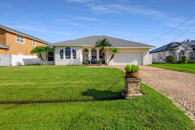 view of front of home with a front yard and a garage