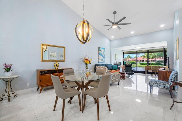 dining room with light tile patterned flooring, ceiling fan with notable chandelier, and high vaulted ceiling