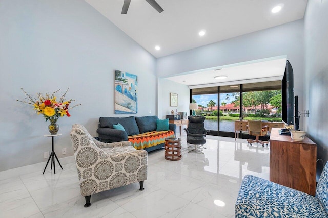 living room with ceiling fan, vaulted ceiling, and light tile patterned floors