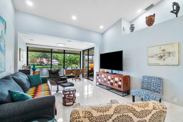 living room featuring high vaulted ceiling and light tile patterned floors