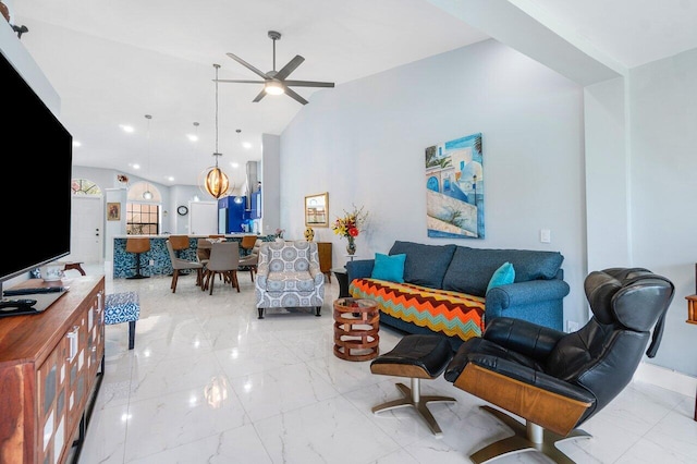 tiled living room with ceiling fan and vaulted ceiling