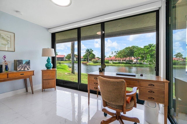 office area featuring a water view and light tile patterned floors