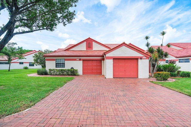 view of front facade with a front yard and a garage