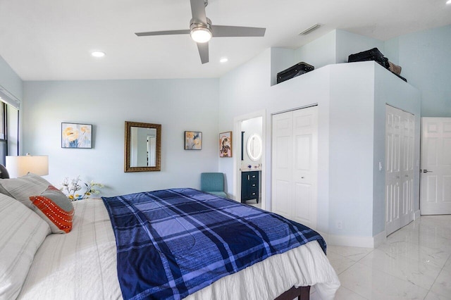 tiled bedroom featuring ceiling fan, two closets, and vaulted ceiling