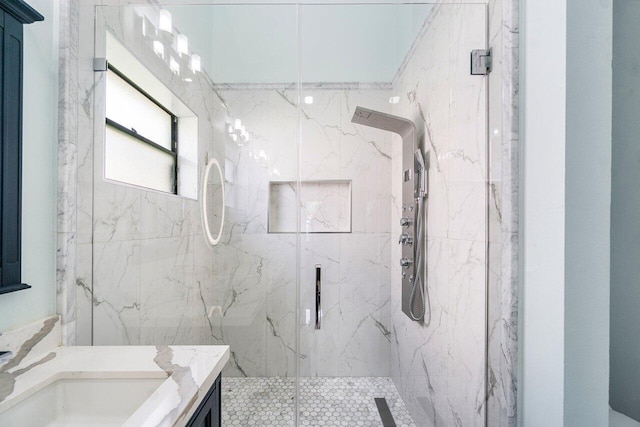 bathroom featuring an enclosed shower and vanity