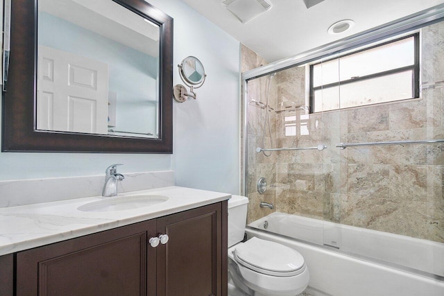 full bathroom with toilet, vanity, and bath / shower combo with glass door