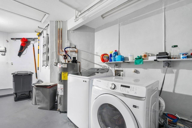 clothes washing area featuring washing machine and dryer and electric water heater