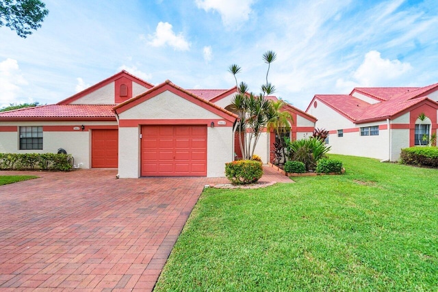 view of front facade with a front yard and a garage