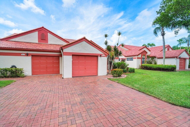 ranch-style home with a garage and a front yard