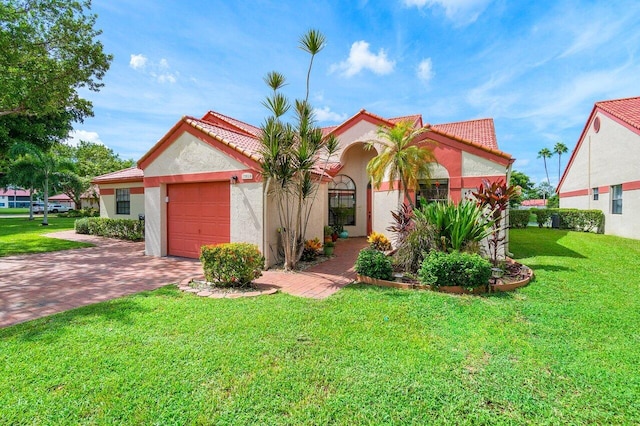 view of front of home with a front lawn and a garage