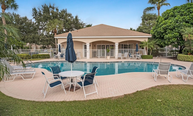 view of swimming pool featuring a yard and a patio area