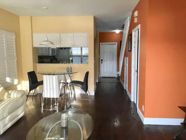 kitchen with dark hardwood / wood-style flooring and white cabinetry