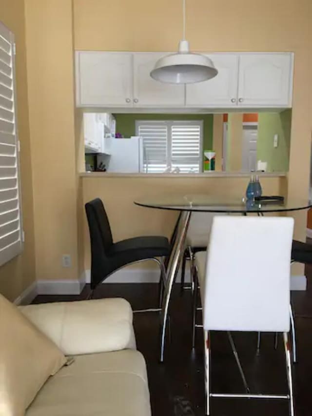 kitchen with white refrigerator and white cabinetry