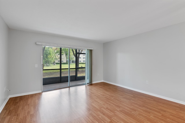 empty room with hardwood / wood-style floors