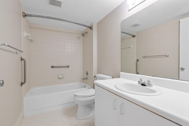 full bathroom with tiled shower / bath combo, tile patterned floors, vanity, and toilet