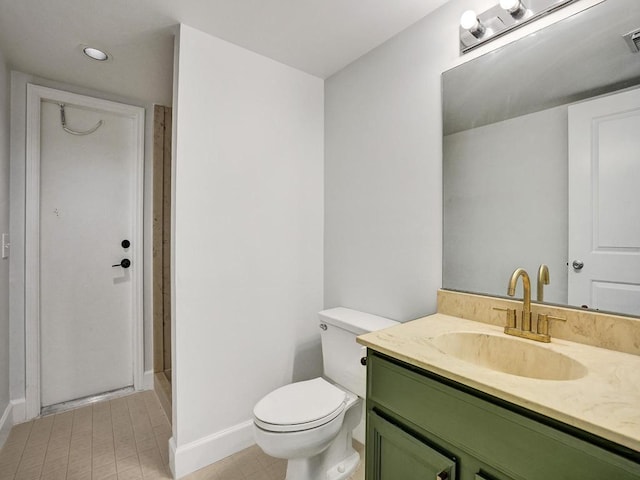 bathroom featuring tile patterned flooring, vanity, and toilet