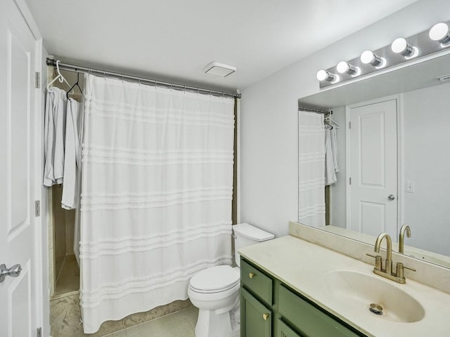 bathroom with toilet, vanity, and tile patterned floors