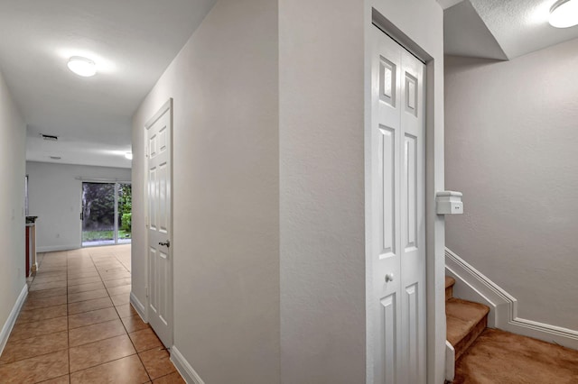 hallway with light tile patterned floors