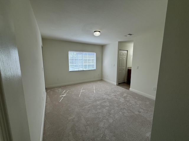 unfurnished room with light carpet