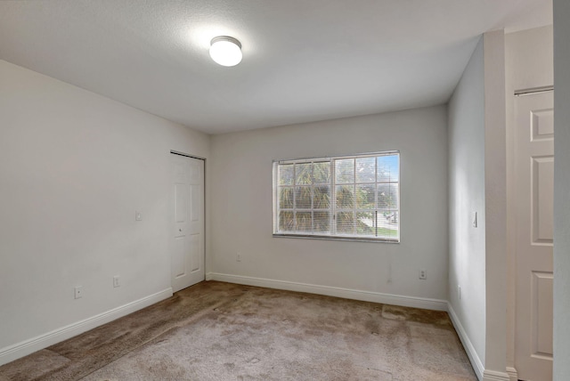 spare room with light colored carpet