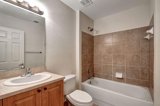 full bathroom featuring vanity, toilet, and tiled shower / bath