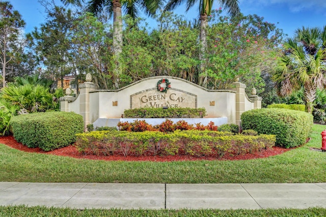 community sign featuring a lawn